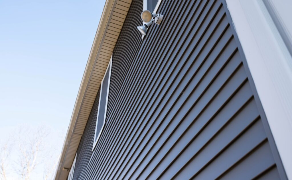 Home exterior with newly installed gray siding.
