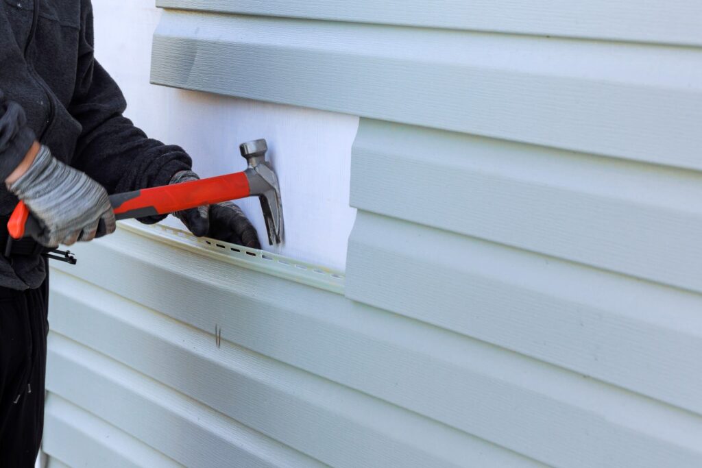 Close-up of siding repair on a Milton, VT home exterior.